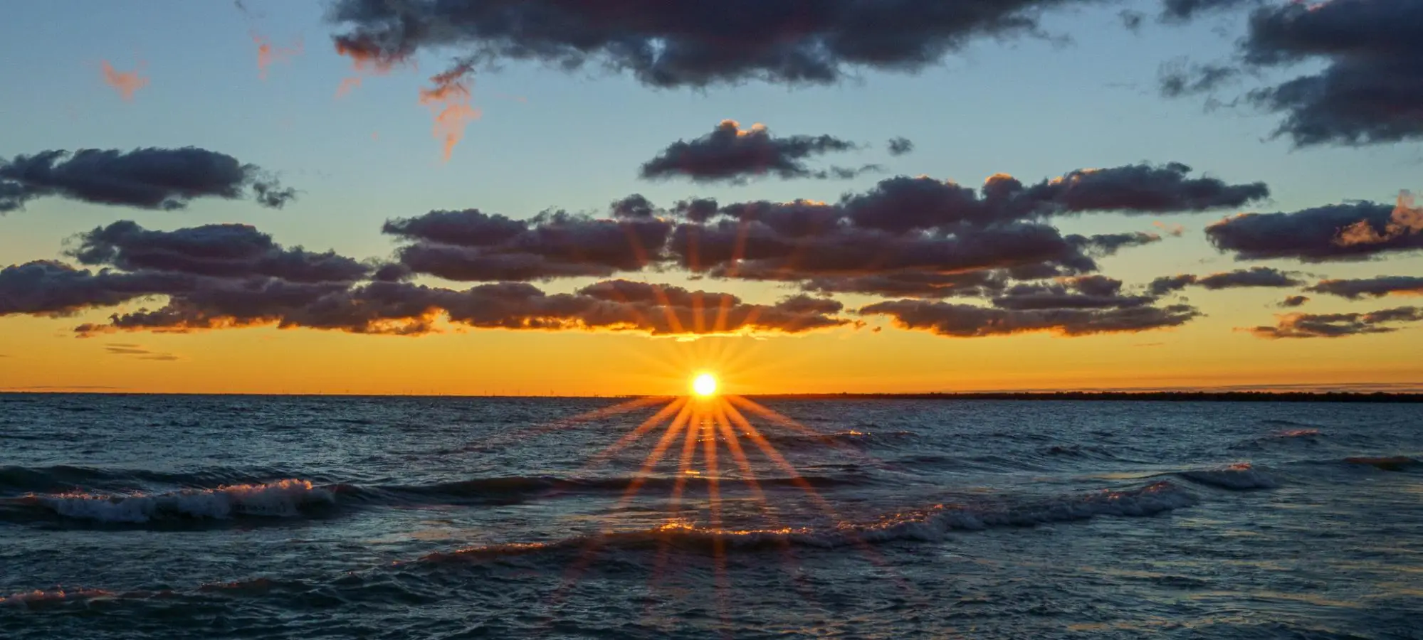 Image of a sunset over the ocean.