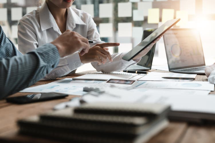 Two people in the office using digital document process solutions