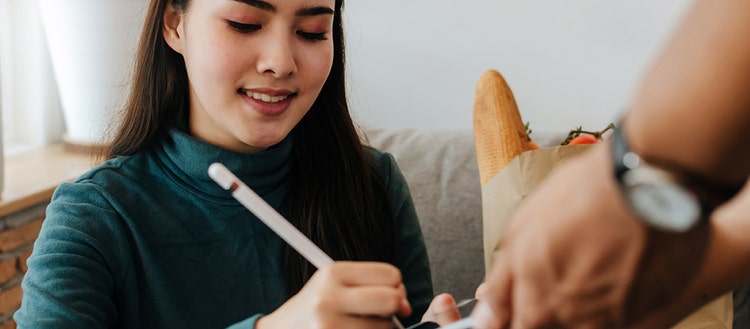 Woman signing a digital signature.