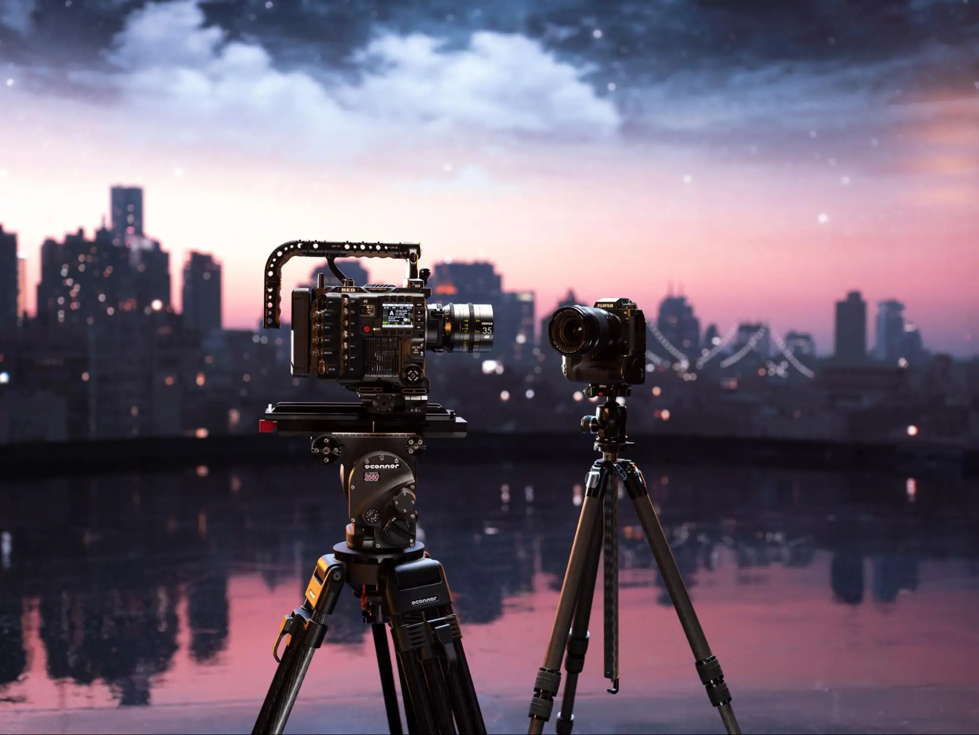 Image of two cameras on tripods with a skyline in the background.
