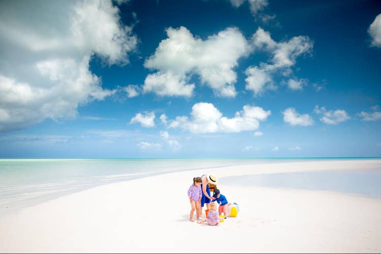 A balanced family portrait on the beach.