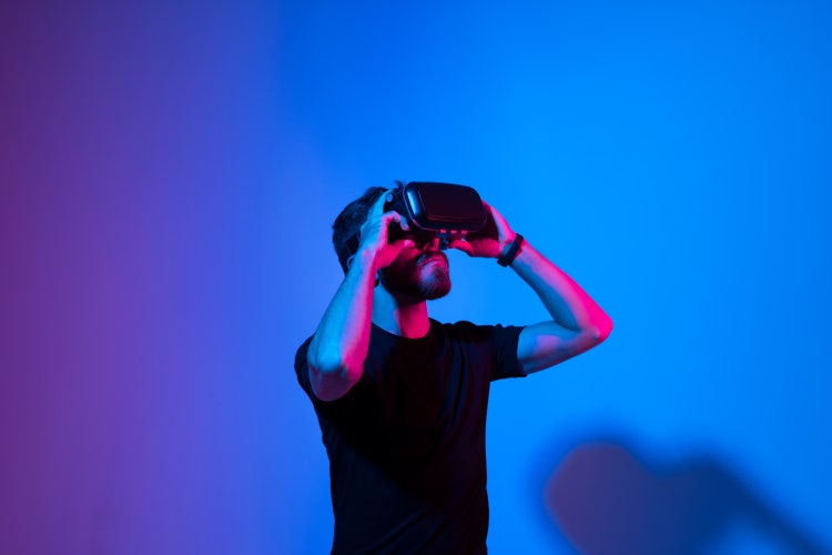 Man looking throughj a virtual reality headset