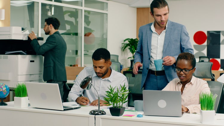 Working together in the office with a printer.