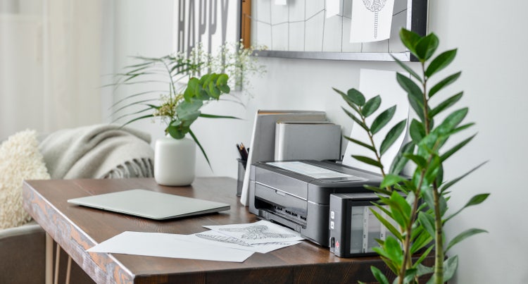 Image of a printer on a desk.