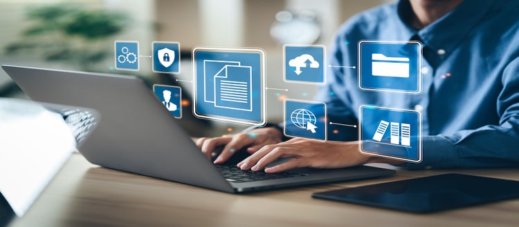 Man typing on laptop with an overlay of several digital-related icons.