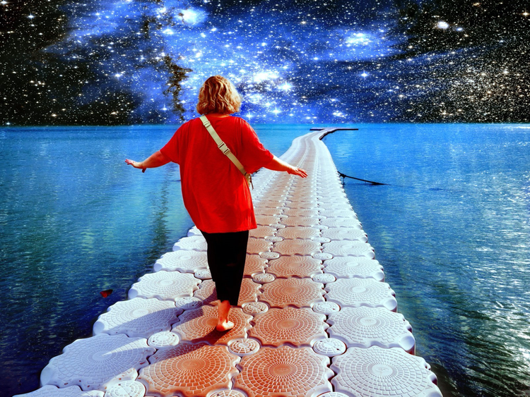 A person walks along the ocean against the background of stars and galaxies.