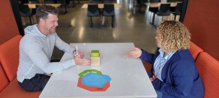 Two people sitting at a table.
