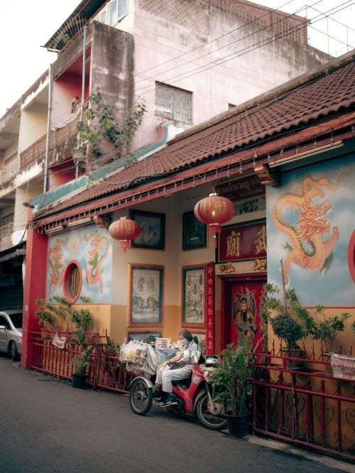 Photo of a building with lanterns and dragon artwork