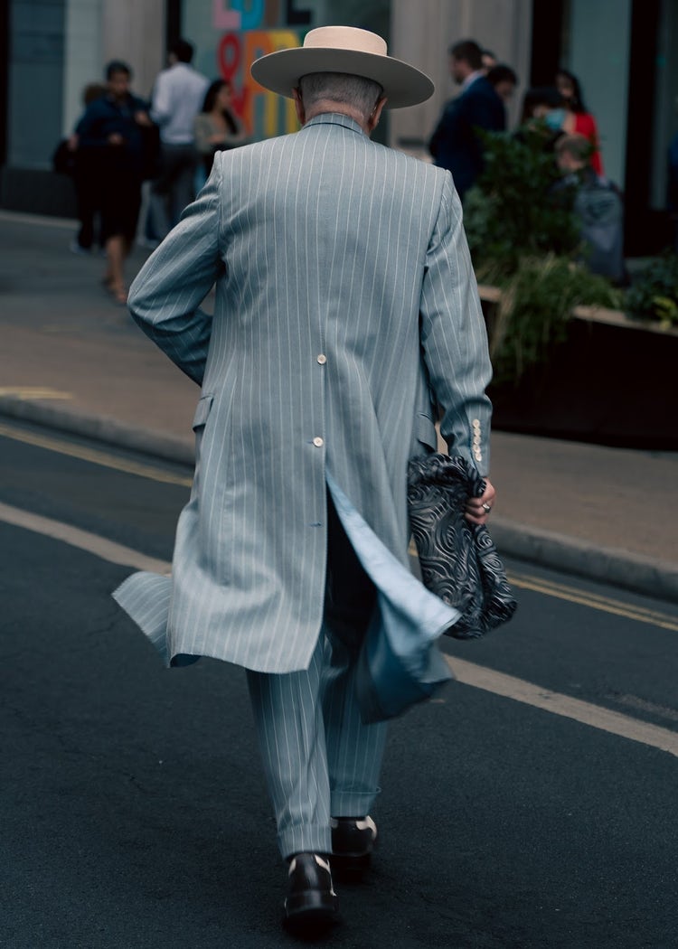Image of a man walking from behind.