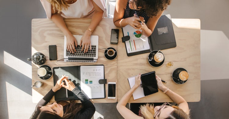 Group of women working together in coffee shop.