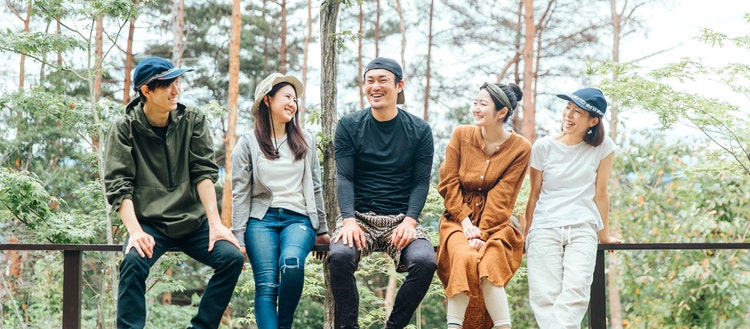 Group of people sitting in the forest.