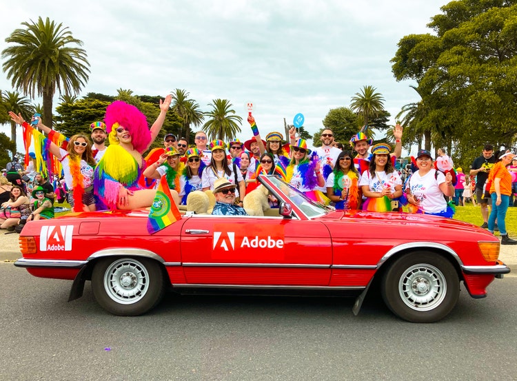 Art Simone riding on the back of an Adobe branded car