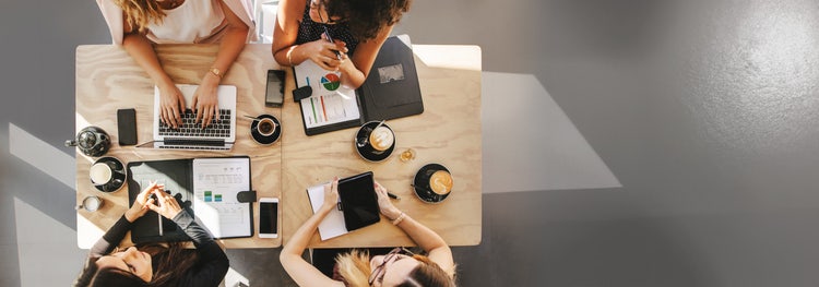 Group of people working at a table together.