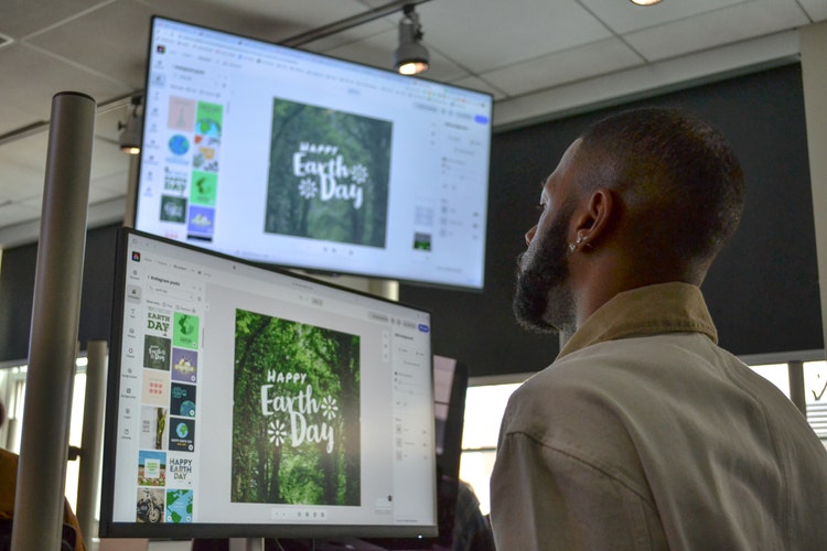 Man looking at computer screens.