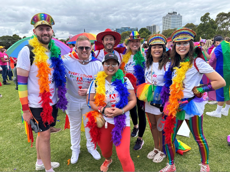 Adobe Australia employees dressed up in colorful clothing.