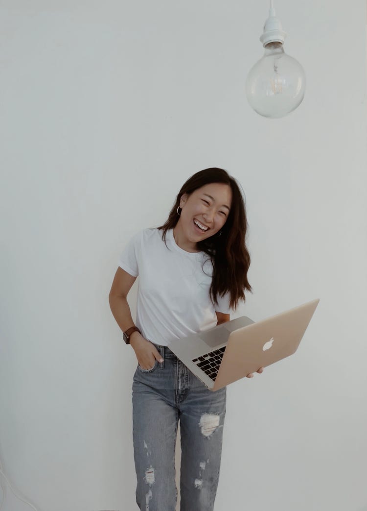 Image of JeeIn Youn holding a laptop.