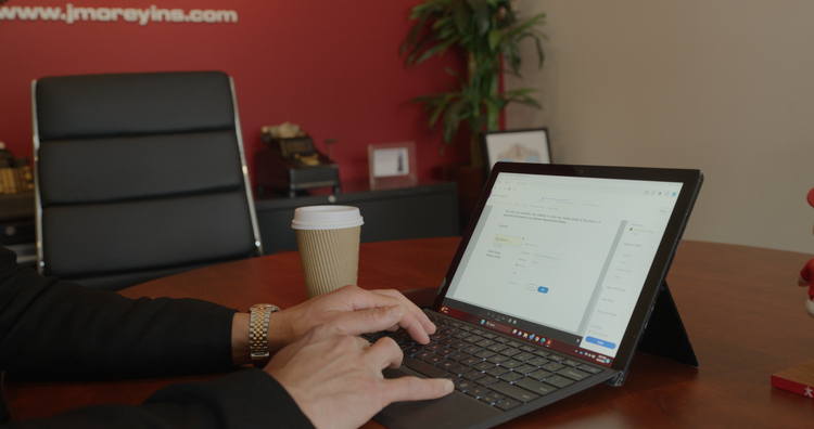 Image of a laptop being used at a J. Morey Inc. office.
