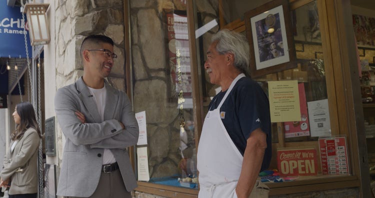 Joshua Morey talking to a man.