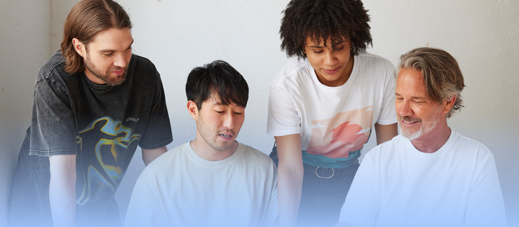 Group of peple looking at something together.