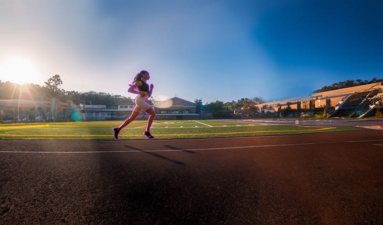 A person running on a track Description automatically generated