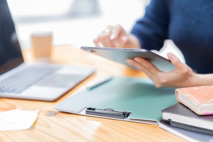 Business Documents concept : Employee woman hands working in Stacks paper files.