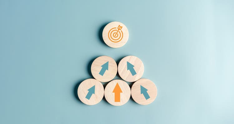 Wooden arrow pieces pointing to a target.