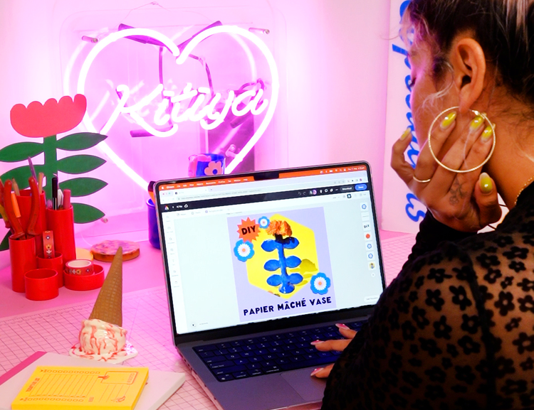 Kitiya at her studio desk working on Adobe Express on her laptop