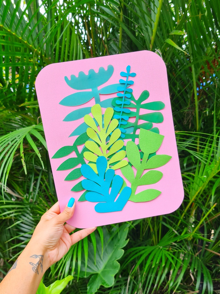 handmade papercrafts of green plants on a pink board