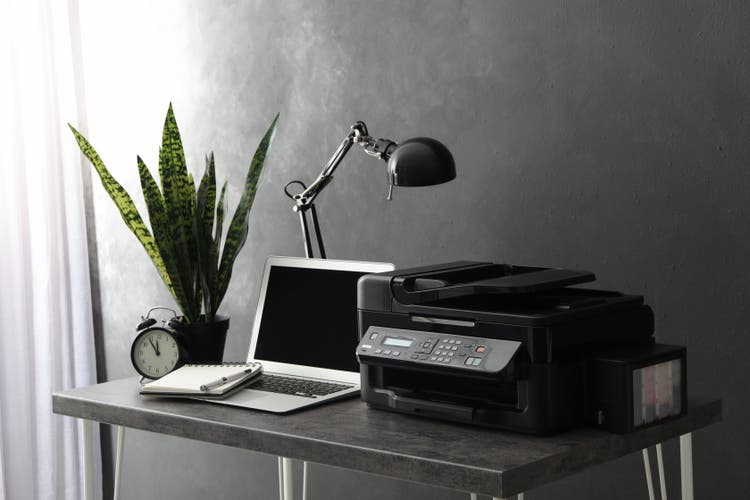 Printer sitting on a desk.