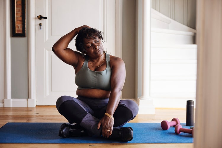 Image of a woman stretching on a mat.