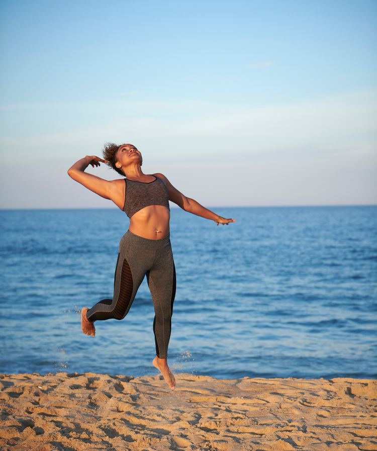 Women playing volleyball on the beach.