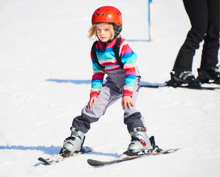 Young girl skiing in the snow.