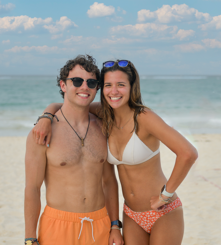 Couple standing on the beach.