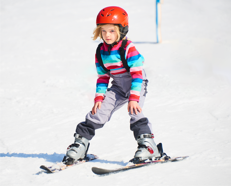 Young girl skiing in the snow.