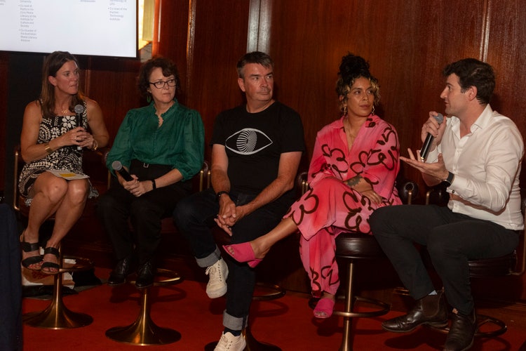 5 people sitting on stools for a panel discussion