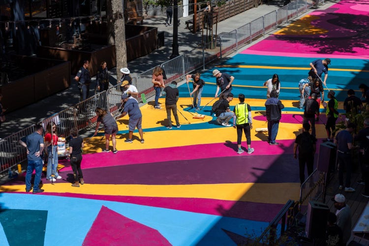 Group of people helping to paint.