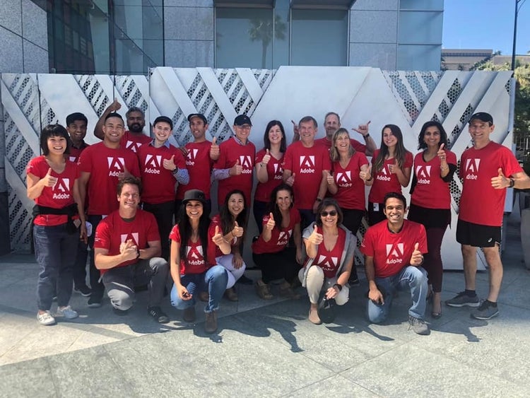 Group of people wearing red Adobe shirts.