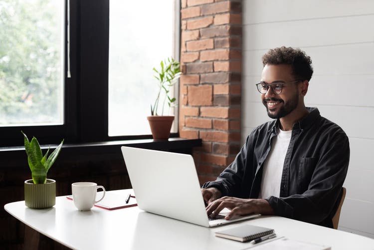 Man sitting working on his laptop.