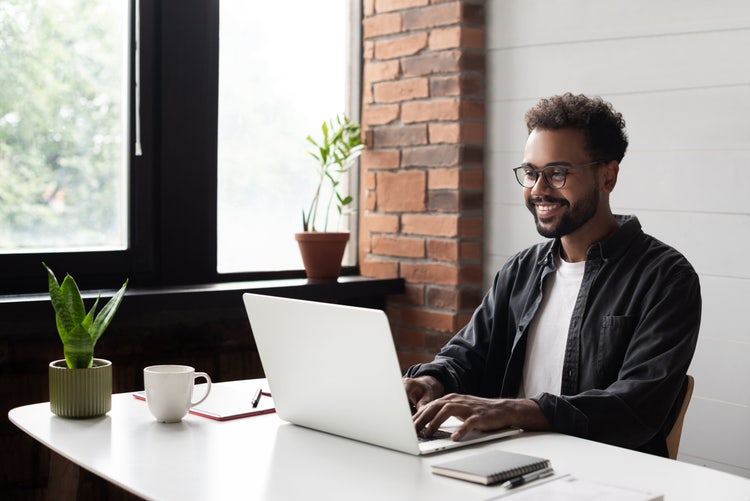 Man sitting working on his laptop.
