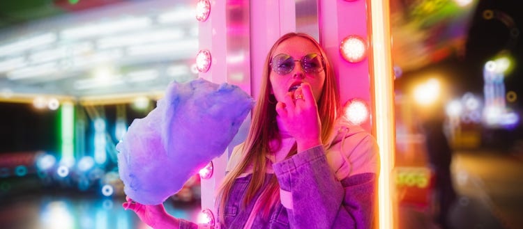Image of a girl eating cotton candy made colorful after being edited in Lightroom.