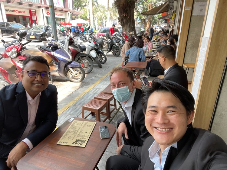 Image of Kok Jong (KJ) at a table with other men.