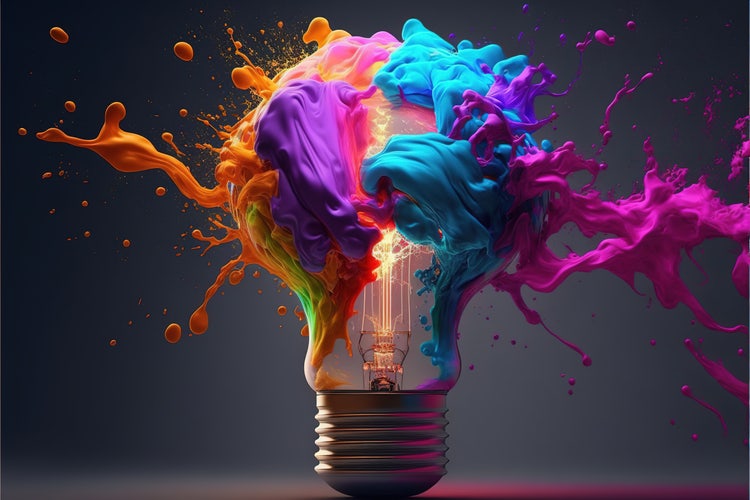 Lightbulb exploding with multi-coloured paint