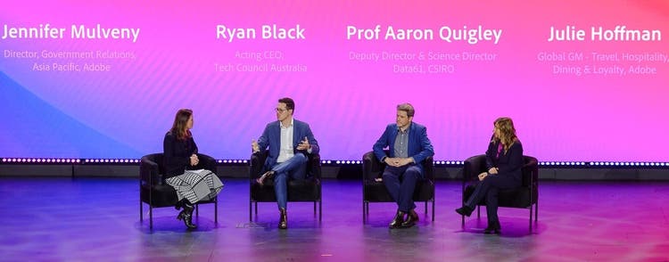 Panel of 4 people sitting up on stage.