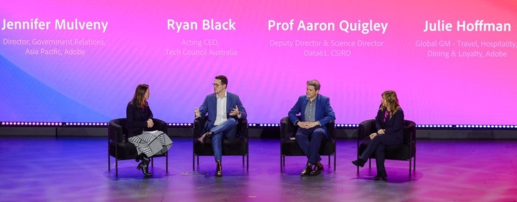 Panel of 4 people sitting up on stage.