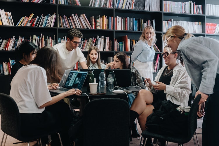 Group of people around computers.