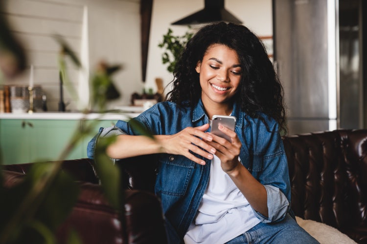 Woman sitting on her phone.