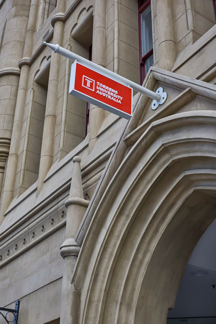 Red sign for university hanging off building