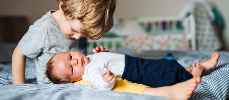 Image of child holding a baby.