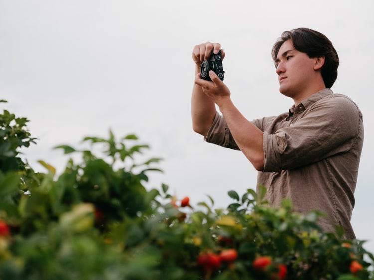 Image of a man taking a picture.