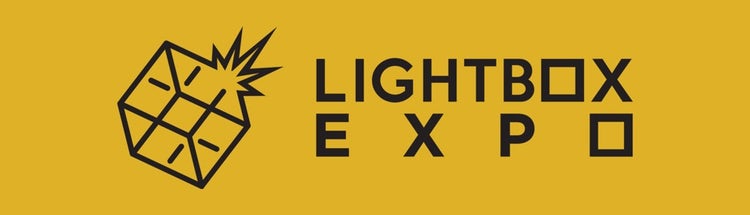 A yellow sign with black text that says LightBox EXPO.